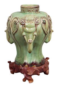Chinese Green Porcelain Three Elephant Vase, early 20th c., Vase- H.- 8 in., Dia.- 7 3/4 in. (2: Chinese Green Porcelain Three Elephant Vase, early 20th c., the underside with three impressed marks, together with a carved mahogany stand, Vase- H.- 8 in., Dia.- 7 3/4 in. (2 Pcs.)