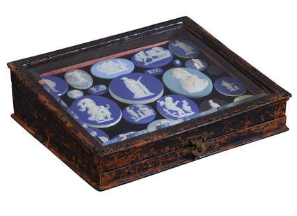 Group of Twenty-Five Wedgwood Plaques, 18th/19th c., Largest- Dia.- 2 1/2 in.; Case- H.- 3 in., W.-9: Group of Twenty-Five Wedgwood Plaques, 18th/19th c., of oval, round, and octagonal form, presented in a beveled glass top collector's display case, consisting of 21 blue examples, 2 green example,