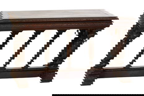 French Renaissance Style Carved Walnut Library Table, late 19th c., H.- 30 3/4 in., W.- 53 1/4 in.,: French Renaissance Style Carved Walnut Library Table, late 19th c., the stepped moulded rectangular top over finialed trestle form masked base with paired cup and cover supports, on a stretchered