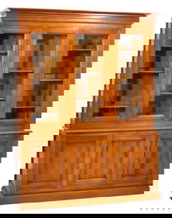French Louis Philippe Style Cherry Bookcase, 20th c., H.- 86 1/2 in., W.- 67 in., D.- 19 in.: French Louis Philippe Style Cherry Bookcase, 20th c., the superstructure with a flared cornice over three glazed doors, revealing a shelved interior, atop the base with canted top, over three lower do