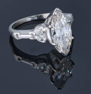 Lady's Platinum Diamond Solitaire Ring, Total Diamond Wt.- app. 3.24 cts., Size- 5.: Lady's Platinum Diamond Solitaire Ring, the center mounted app. 2.60 carat marquise cut diamond, flanked by a 0.20 carat half moon diamond and a 0.12 carat baguette diamond on each side of the band, T