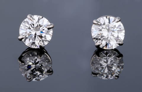 Pair of Platinum Diamond Stud Earrings, Total Diamond Wt.- 1.43 carats (2 Pcs.): Pair of Platinum Diamond Stud Earrings, from Adler's, New Orleans, one stud with a 0.70 carat E color internally flawless diamond, the other with a 0.73 carat F color internally flawless diamond, with
