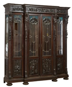 French Renaissance Revival Stained Glass Carved Walnut Bookcase, late 19th c., H.- 93 in., W.- 78