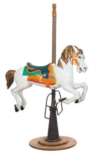 American Polychromed Wood and Iron Carousel Horse, 20th c., H.- 70 in., W.- 44 in., D.- 24 in.: American Polychromed Wood and Iron Carousel Horse, 20th c., the finialed twist brass standard above prancing white pony, iron stirrups, reverse tapered iron base on wood stand, H.- 70 in., W.- 44 in.,