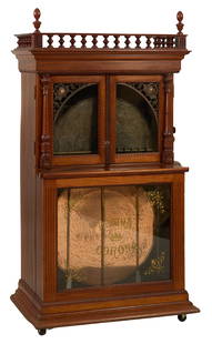 Regina Corona Music Box, early 20th c., H.- 73 in., W.- 39 in., D.- 25 1/2 in.: Regina Corona Music Box, early 20th c., with 27" disc automatic changer, in a Honduran mahogany case, stamped serial # 887, H.- 73 in., W.- 39 in., D.- 25 1/2 in.