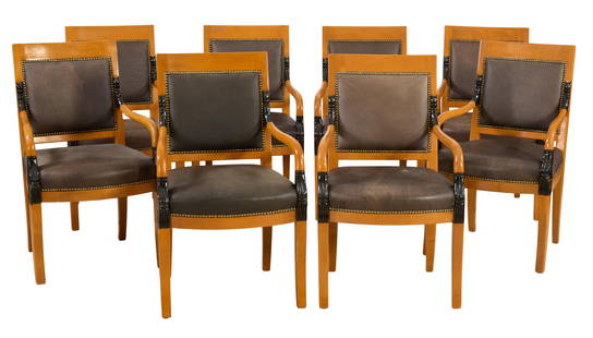 Eight Biedermeier Style Ebonized Carved Beech Arm Chairs, 20th c., H.- 38 in., W.- 23 in., D.- 25: Eight Biedermeier Style Ebonized Carved Beech Arm Chairs, 20th c., the rectangular backs with nailhead trimmed upholstered panel, downswept arms with stylized dolphin terminus, reeded block over saber