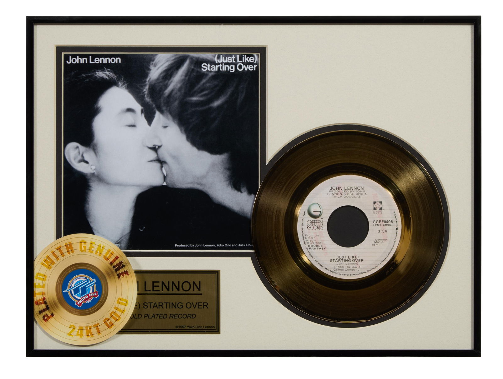 John Lennon "(Just Like) Starting Over" Memorabilia, 1997, Overall- H.- 12 in., W.- 16 in.: John Lennon "(Just Like) Starting Over" Memorabilia, 1997, 24 karat gold plated 45 record, limited edition, presented with reproduced album cover and a gilded plaque, in a black metal frame, Overall-