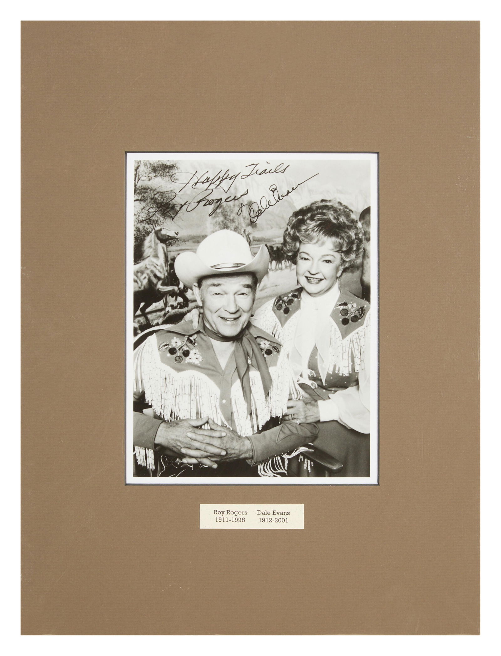 Roy Rogers and Dale Evans Autographed Memorabilia from "Happy Trails" (1986-1989), Overall- H.-16: Roy Rogers and Dale Evans Autographed Memorabilia from "Happy Trails" (1986-1989), silver gelatin print of the couple from the TV set, signed and inscribe, matted with paper plaques, in a plastic slee