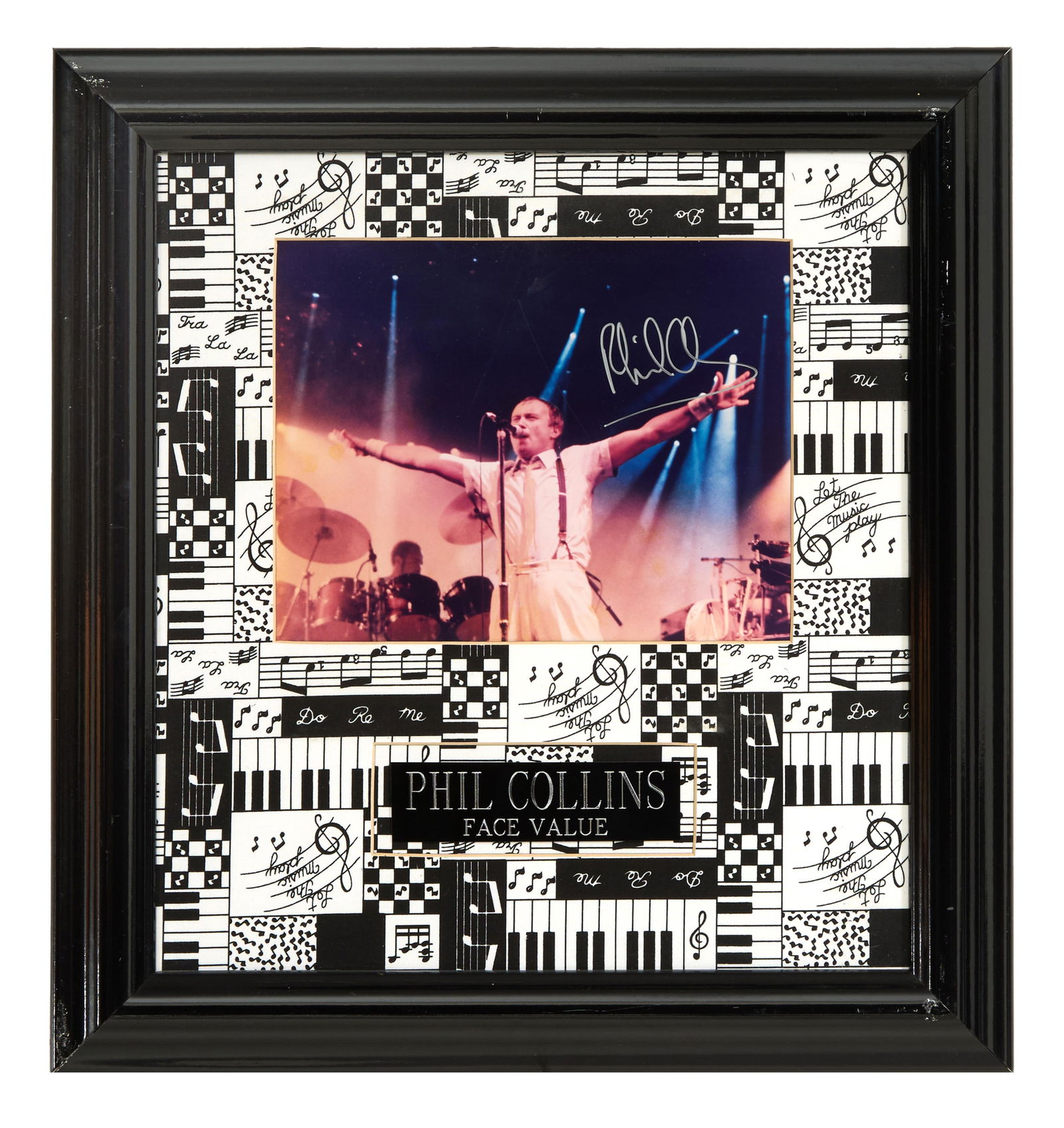 Phil Collins "Face Value" Autographed Memorabilia, Overall- H.- 19 1/2 in., W.- 18 1/4 in.: Phil Collins "Face Value" Autographed Memorabilia, with signed color photo of Collins on "Face Value Tour" in 1981, presented with artist and album plaque on a musical printed border, in a black frame