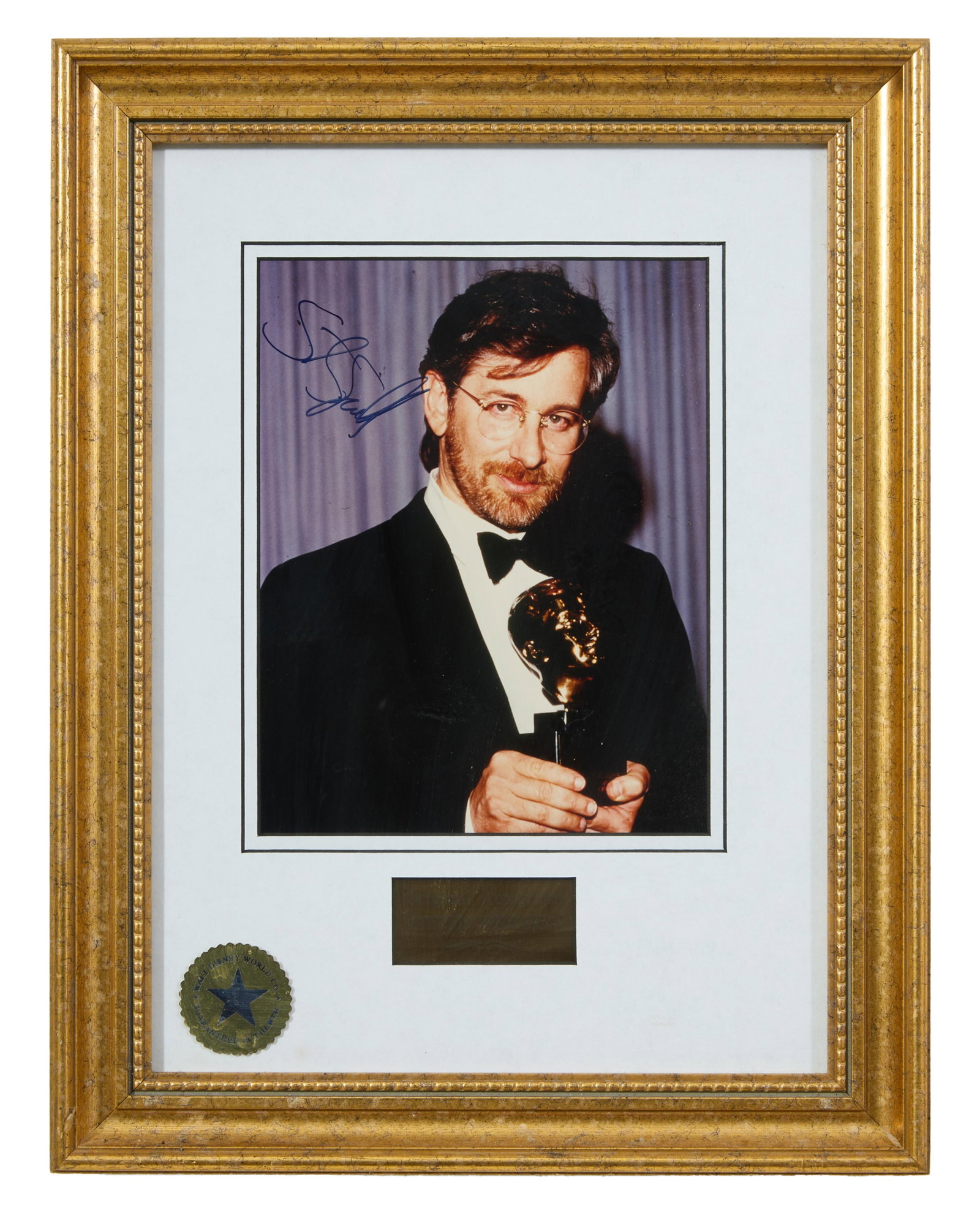 Steven Spielberg Autographed Memorabilia, Image- H.- 9 in., W.- 7 in., Framed- H.- 17 5/8 in., W.-: Steven Spielberg Autographed Memorabilia, color photograph of Steven Spielberg holding an Academy Award, signed in blue ink upper left, with gold-toned plaque lower center inscribed “Original Autogr