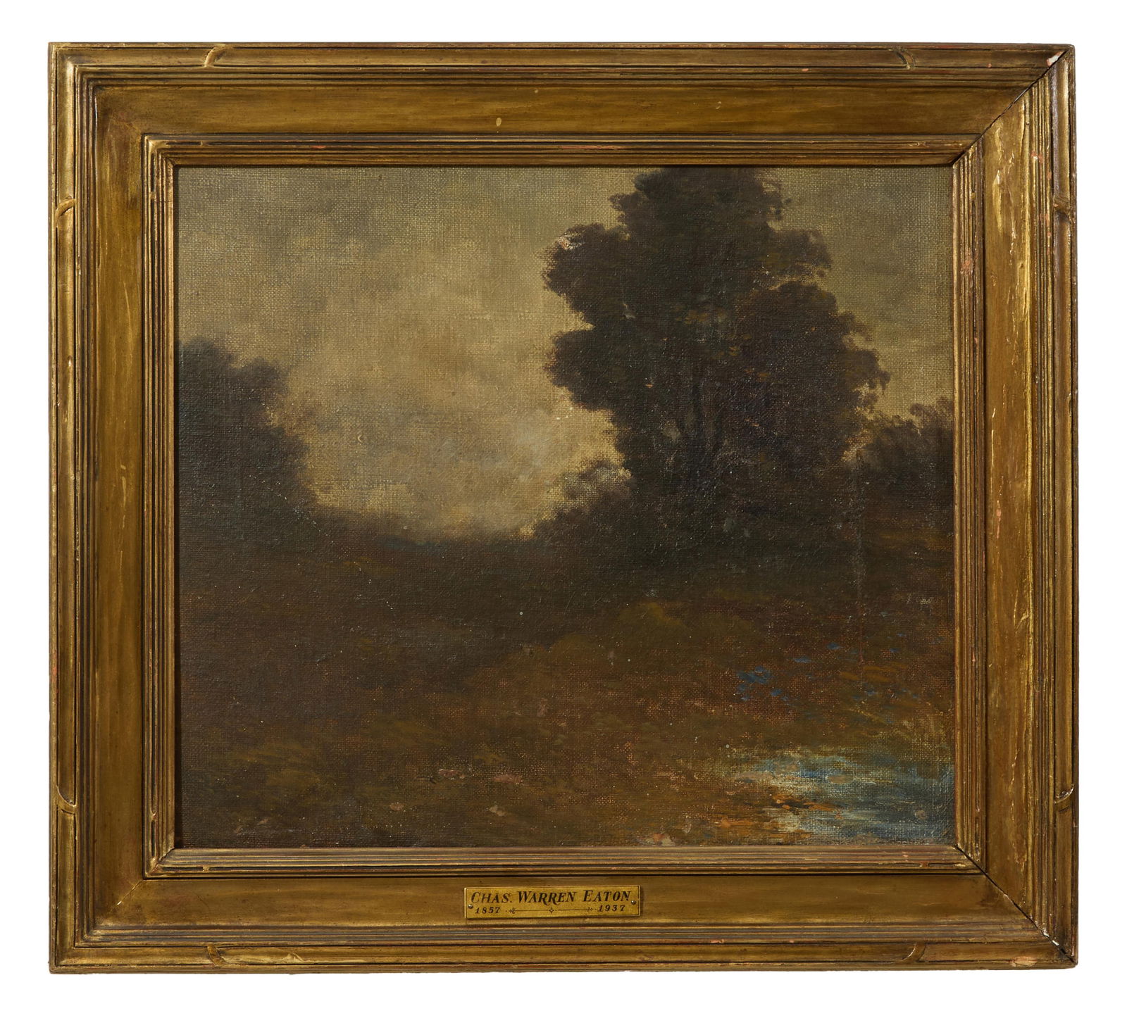 Attributed to Charles Warren Eaton (American/New York, 1857-1937), "Wooded Landscape,": Attributed to Charles Warren Eaton (American/New York, 1857-1937), "Wooded Landscape," oil on canvas, unsigned, presented in a giltwood frame with artist plaque, H.- 14 1/8 in., W.- 16 1/8 in., Framed