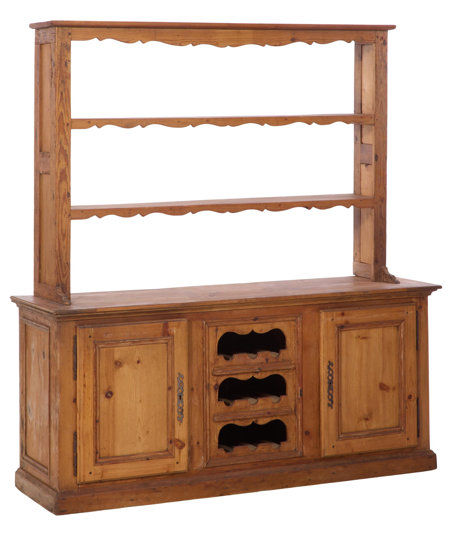 French Provincial Pine Vaisselier, 20th c., H.- 70 1/2 in., W.- 65 1/2 in., D.- 19 in.: French Provincial Pine Vaisselier, 20th c., the superstructure with a flat top, spurred and lobbed crest and shelf fronts, base with central three cubby wine storage flanked by raised panel doors, mou