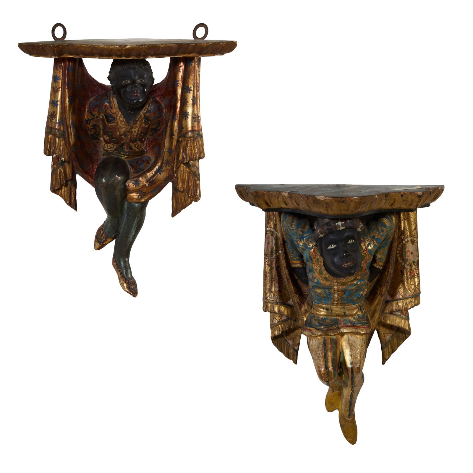 Near Pair of Gilt and Polychromed Plaster Blackamoor Wall Brackets, early 20th c., First- H.- 14 1/2: Near Pair of Gilt and Polychromed Plaster Blackamoor Wall Brackets, early 20th c., the shaped tops on gilt and polychromed Nubian supports, First- H.- 14 1/2 in., W.- 10 3/4 in., D.- 7 in.; Second- H.