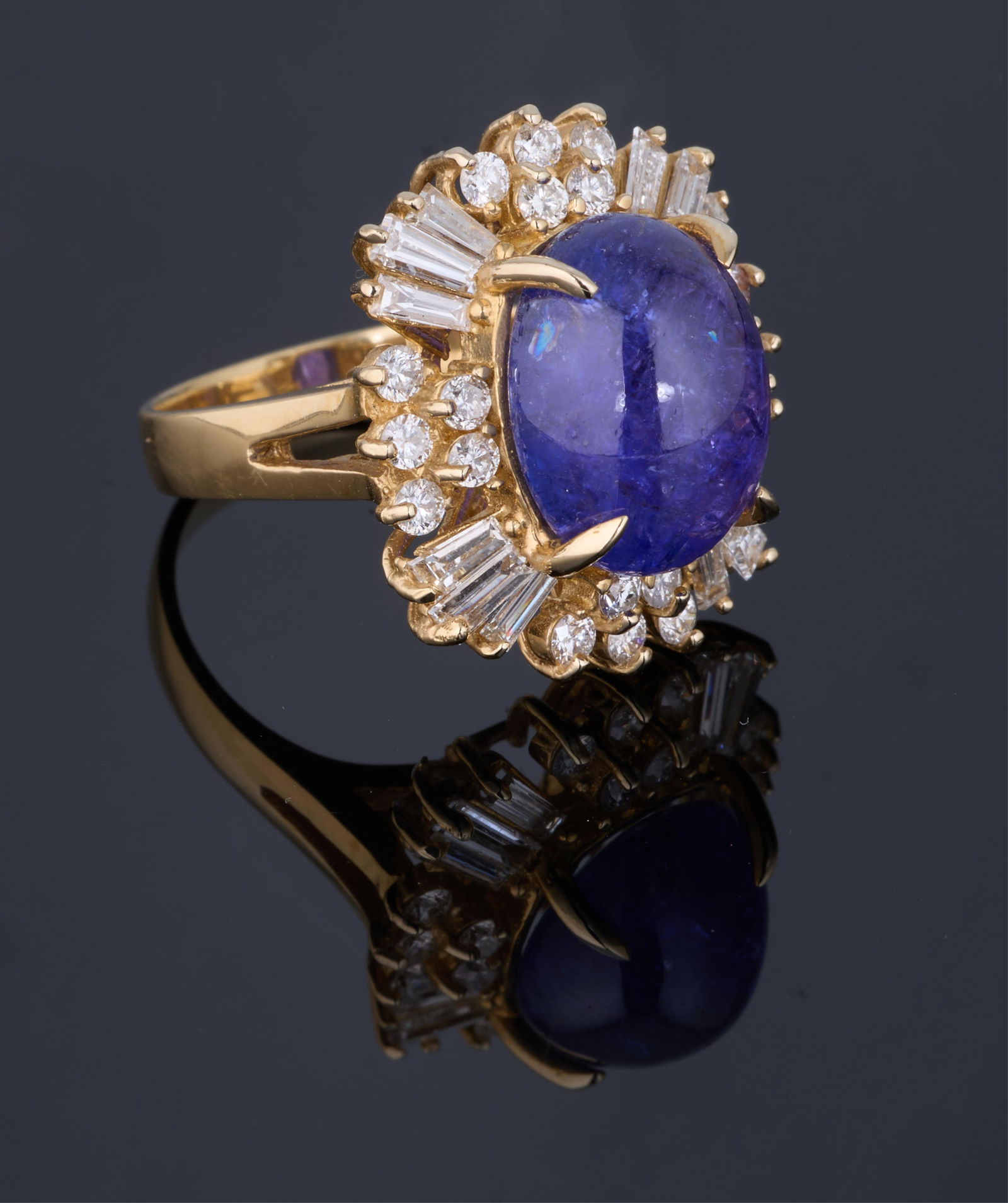 Ladies' 14K Gold Tanzanite and Diamond Dinner Ring, Total Diamond Wt.- 1.45 carat, Size- 6 1/2, with: Ladies' 14K Gold Tanzanite and Diamond Dinner Ring, the center mounted 10.10 carat cabochon oval tanzanite atop a surrounding border of round and baguette diamonds, Total Diamond Wt.- 1.45 carat, Size