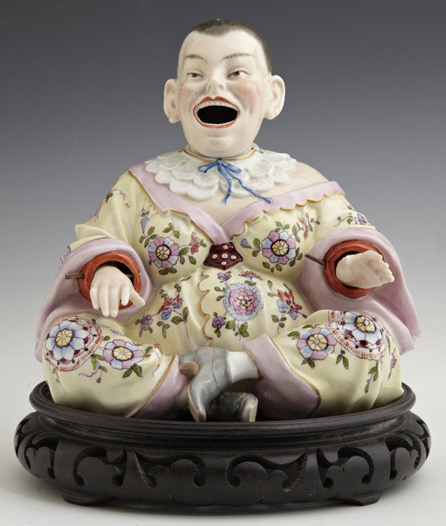German Polychromed Porcelain Nodder Figure, late 19th c: German Polychromed Porcelain Nodder Figure, late 19th c., of a Chinese woman, in a floral decorated robe, the underside with a blue crossed arrows mark, H.- 8 in., W.- 7 3/8 in., D.- 7 in.