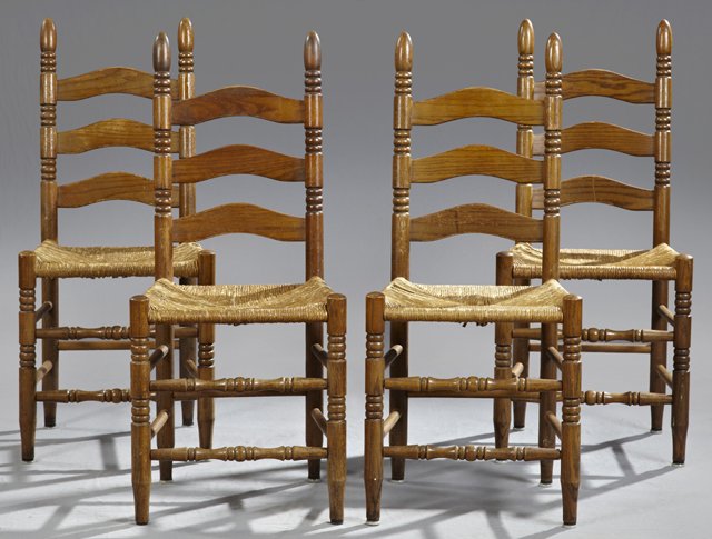 Set of Four American Carved Oak Ladder Back Rush Seat S: Set of Four American Carved Oak Ladder Back Rush Seat Side Chairs, 19th c., with arched ladder backs, on turned supports to rush seats, on turned tapered legs joined by turned stretchers, H.- 40 in.