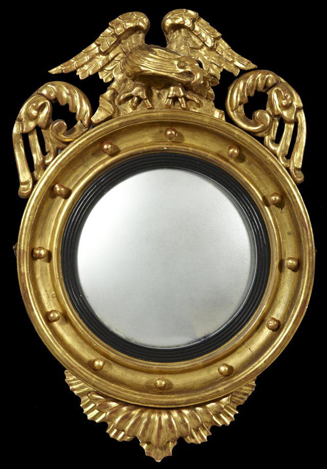 English Regency Gold Leaf and Gesso Convex Bullseye Mir: English Regency Gold Leaf and Gesso Convex Bulls Eye Mirror, circa 1820, the top surmounted by an eagle flanked by leaves, the bottom with a large applied leaf, H.- 28 1/2 in., W.-18 3/4 in, D.- 6 in.
