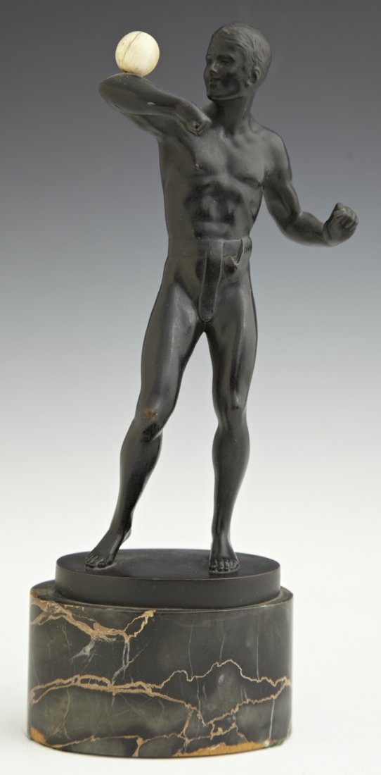 Bruno Zach (1891-1935), "The Juggler," 20th c., patinat: Bruno Zach (1891-1935), "The Juggler," 20th c., patinated bronze of a man balancing an ivory ball on an oval highly figured black marble plinth signed in the rear, H.- 10 1/8 in., W.- 3 3/4 in., D.- 2