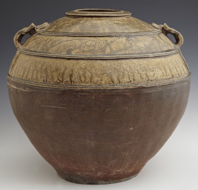 Good Chinese Two-Color Glazed Storage Jar, Western Han: Good Chinese Two-Color Glazed Storage Jar, Western Han Dynasty, 202 B.C.-220 A.D., the bulbous body with a tapered foot, with high relief-molded mask handles and etched scroll designs under an olive g