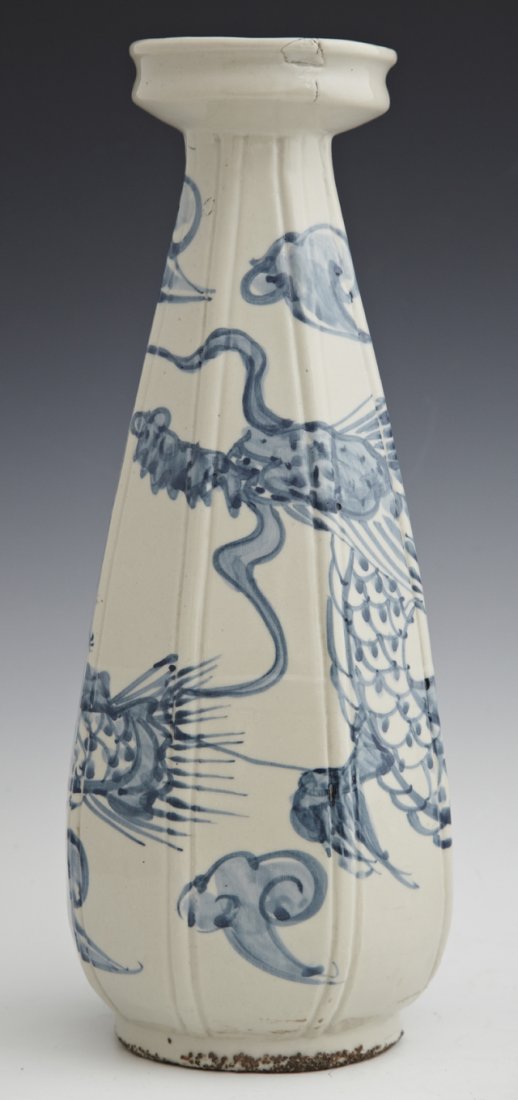 Korean Blue and White Porcelain Modeled Vase, 19th c. t: Korean Blue and White Porcelain Modeled Vase, 19th c. the tapered octagonal body with a flared lip, decorated in underglaze blue on an off-white ground depicting a dragon amongst clouds, H. 10-3/4 in.