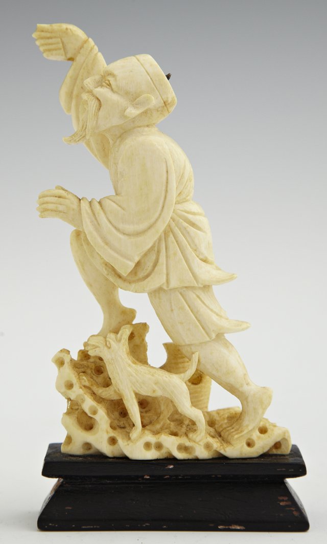 Chinese Carved Ivory Figure, late 19th c., of a man wit: Chinese Carved Ivory Figure, late 19th c., of a man with a dog, mounted on an ebonized wood base. Figure- H.- 4 1/8 in., W.- 2 1/8 in., D.- 1 in. w/ Dog