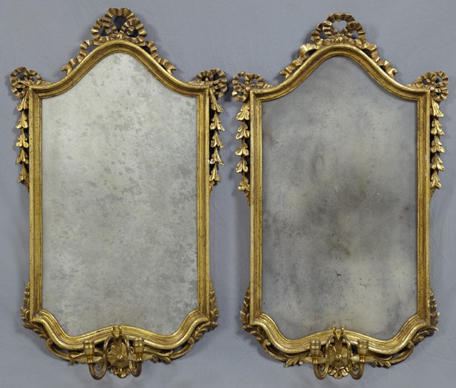 Pair of Louis XV Style Mirror Sconces, 19th c. and late: Pair of Louis XV Style Mirror Sconces, 19th c. and later, the large mirrors with bow and ribbon surmounts and corners, on a stepped molded frame, now with a two light bronze sconce at the bottom cente