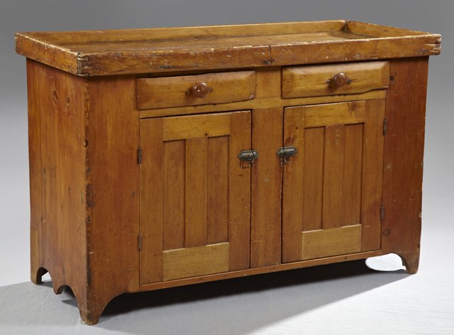 American Carved Pine Dry Sink, 19th c., the galleried t: American Carved Pine Dry Sink, 19th c., the galleried top over two frieze drawers, above paneled cupboard doors, the whole on bracket feet, H.- 33 1/2 in., W.- 52 in., D.- 22 1/4 in.