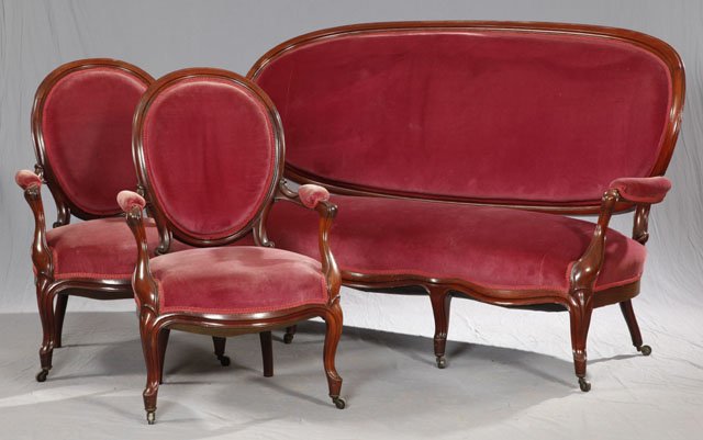 Victorian Carved Mahogany Medallion Back Three Piece Pa: Victorian Carved Mahogany Medallion Back Three Piece Parlor Suite, 19th c., consisting of a triple seat serpentine settee and a pair of fauteuils, each on cabriole legs to toupie feet, upholstered in 