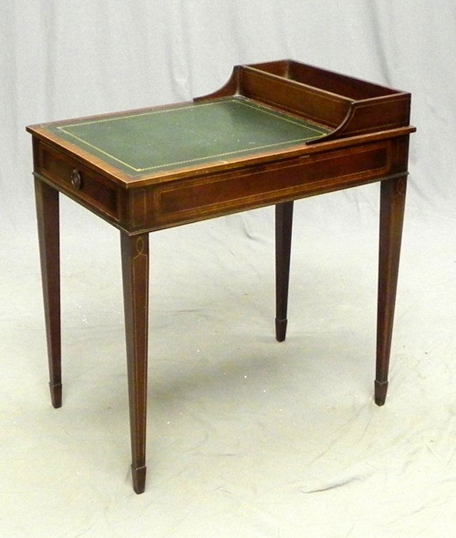 Edwardian-Style Mahogany Chairside Table, mid-20th cent: Edwardian-Style Mahogany Chair Side Table, mid-20th century, the leather-inset rectangular top with a back raised storage well, above a frieze fitted with a single drawer, raised on square tapering le