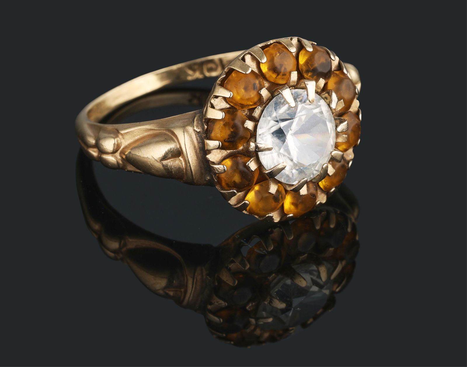 10K Yellow Gold Sapphire Ring, Size- 7.: 10K Yellow Gold Sapphire Ring, the center mounted app. 1 carat round white sapphire within a border of round single cut orange stones, Size- 7.