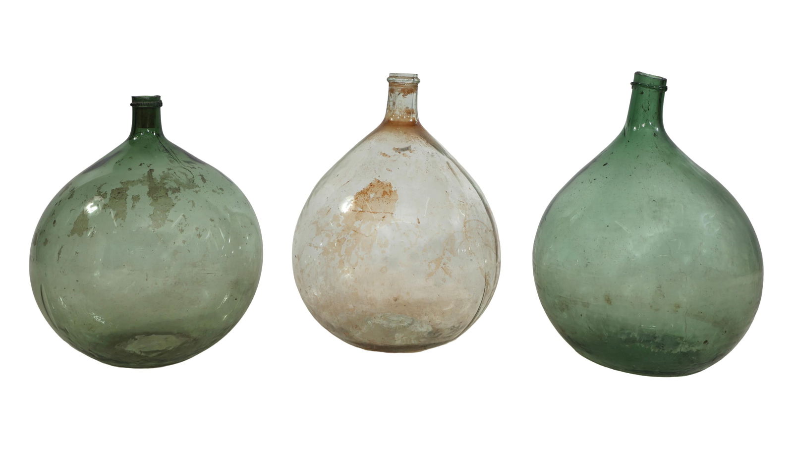 Three French Provincial Blown Glass Carboys, mid-19th c., Largest Green- H.- 19 1/2 in., Dia.- 14 1/: Three French Provincial Blown Glass Carboys, mid-19th c., two in green glass, one clear glass, each with globular bodies, Largest Green- H.- 19 1/2 in., Dia.- 14 1/2 in.; Smallest Green- H.- 17 1/2 in