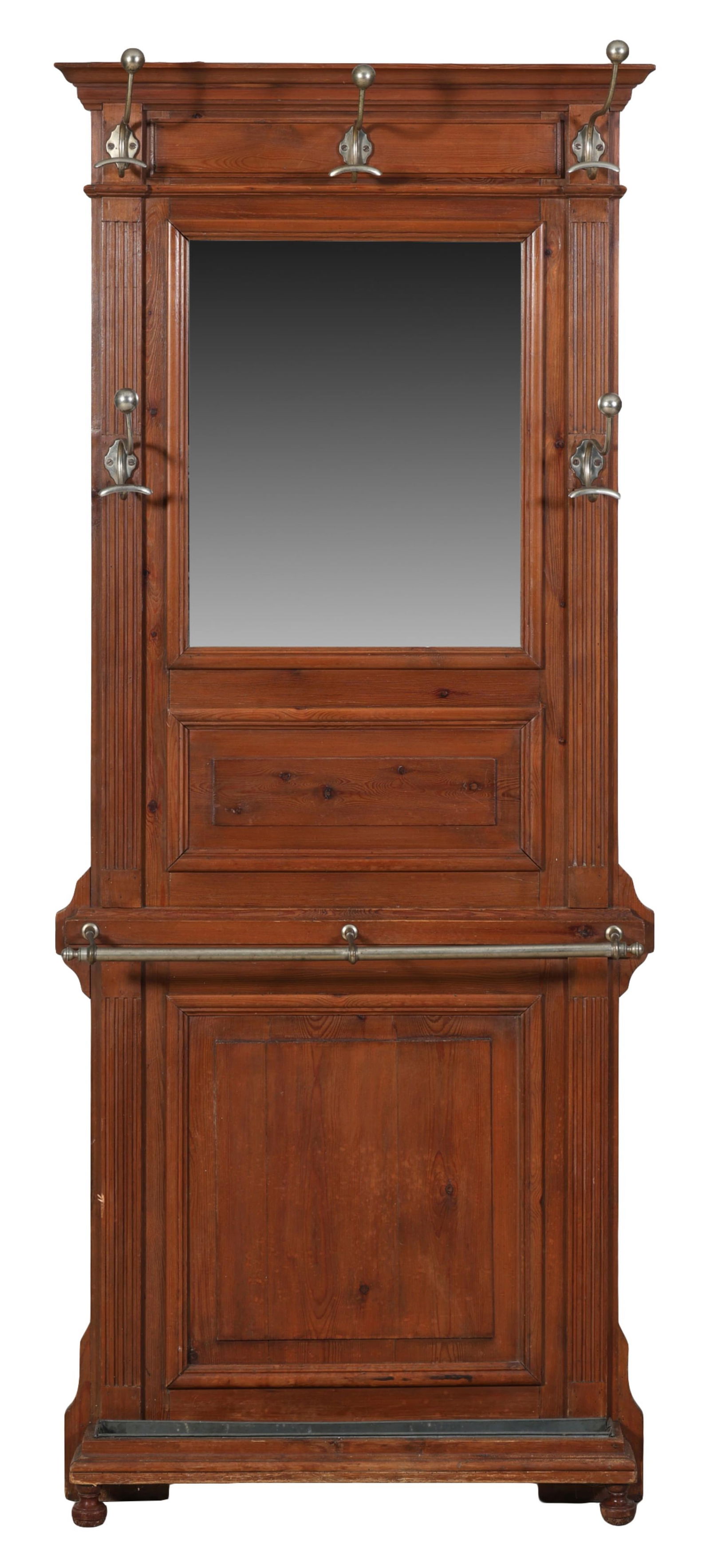 French Provincial Pine Hall Stand, early 20th c., H.- 74 1/2 in., W.- 31 1/8 in., D.- 8 in.: French Provincial Pine Hall Stand, early 20th c., the molded cornice over frieze with three hat and cloak hooks, central mirror flanked by fluted stiles with conforming hooks, mid umbrella rail, lower