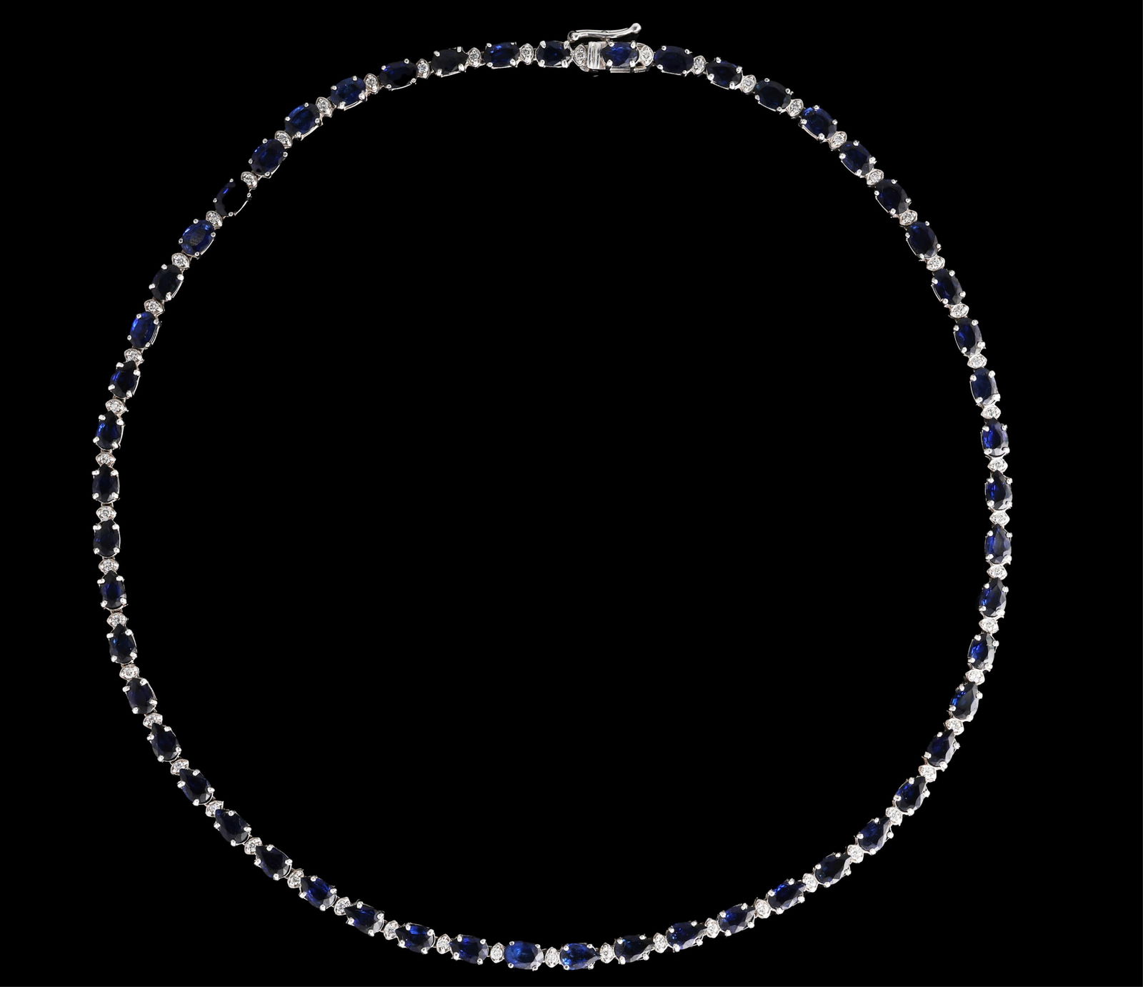 14K White Gold Sapphire and Diamond Necklace, L.- 17 in.: 14K White Gold Sapphire and Diamond Necklace, the necklace with 53 links mounted with oval and pear shaped blue sapphires, separated by small diamond mounted space links, with a tension lock clasp and