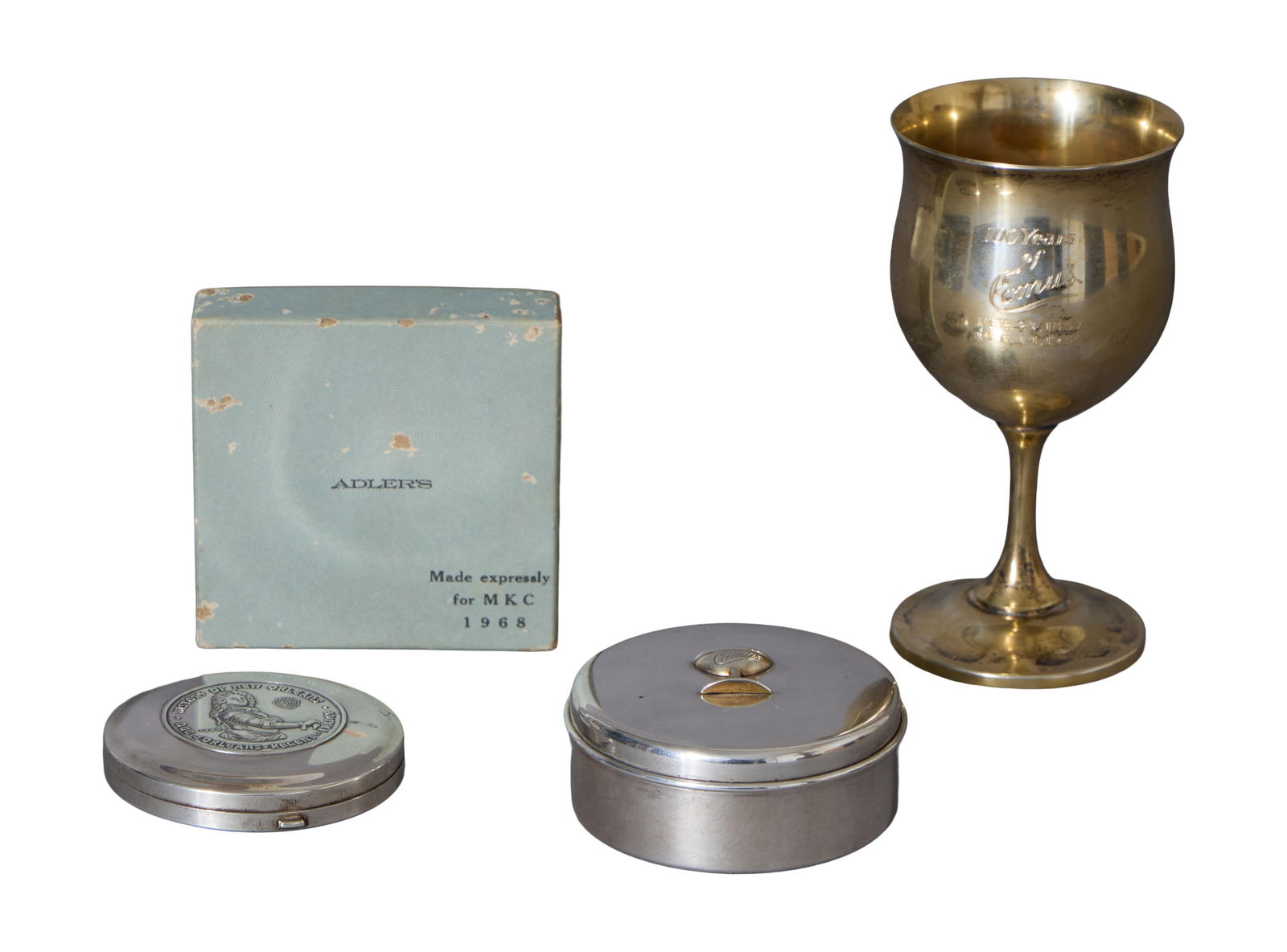 Three Mardi Gras Krewe Favors, Mistick Krewe of Comus, mid 20th c., Ring Box- H.- 1 1/4 in., Dia.- 2: Three Mardi Gras Krewe Favors, Mistick Krewe of Comus, mid 20th c., consisting of a 1956 example, for the 100th anniversary, in the form of a gilt washed sterling Reed & Barton goblet, no. H122, inscr