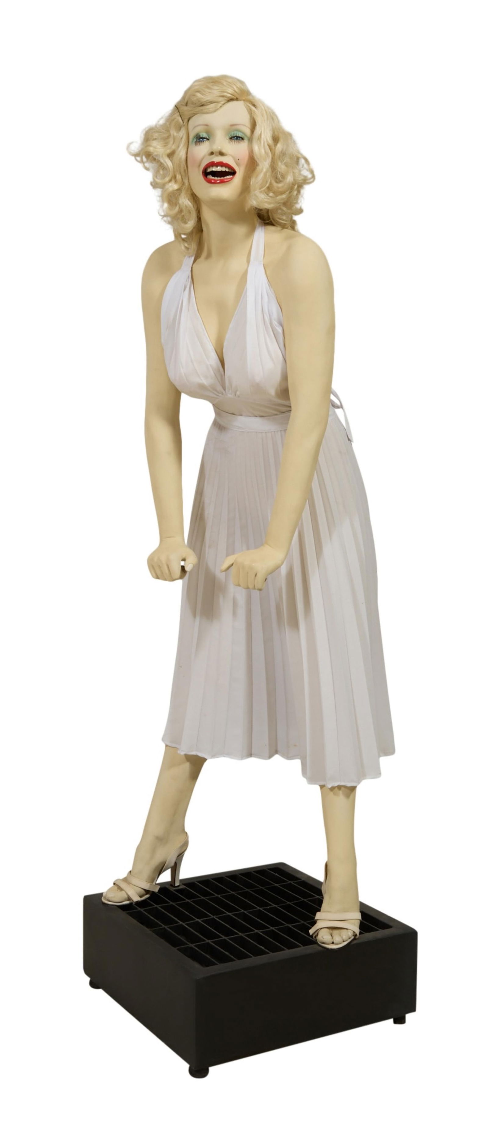 Marilyn Monroe Life Size Painted Fiberglass Statue with Fan, Overall- H.- 72 in., Figure- H.- 64 1/2: Marilyn Monroe Life Size Painted Fiberglass Statue with Fan, depicting the iconic scene from "The Seven Year Itch" (1955), featuring Monroe standing over a subway grate; mounted on a black rectangular