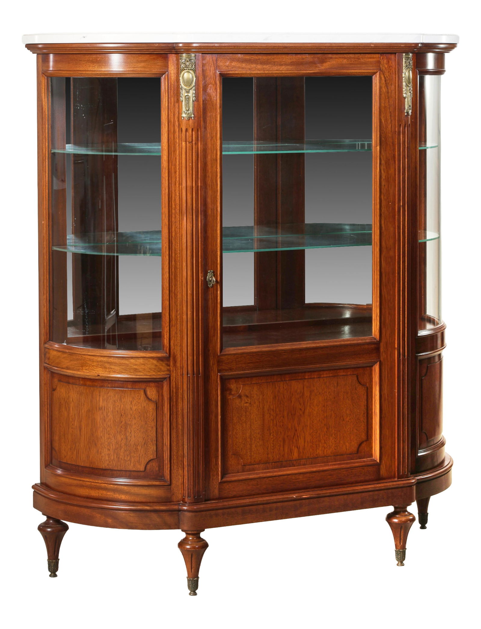 French Louis XVI Style Ormolu Mounted Walnut Curio Cabinet, late 20th c., H.- 63 1/4 in., W.- 55 1/2: French Louis XVI Style Ormolu Mounted Walnut Curio Cabinet, late 20th c., the flat-shaped top over a central glazed door with a lower panel, conforming sides, shelved interior, mounted fluted stiles,