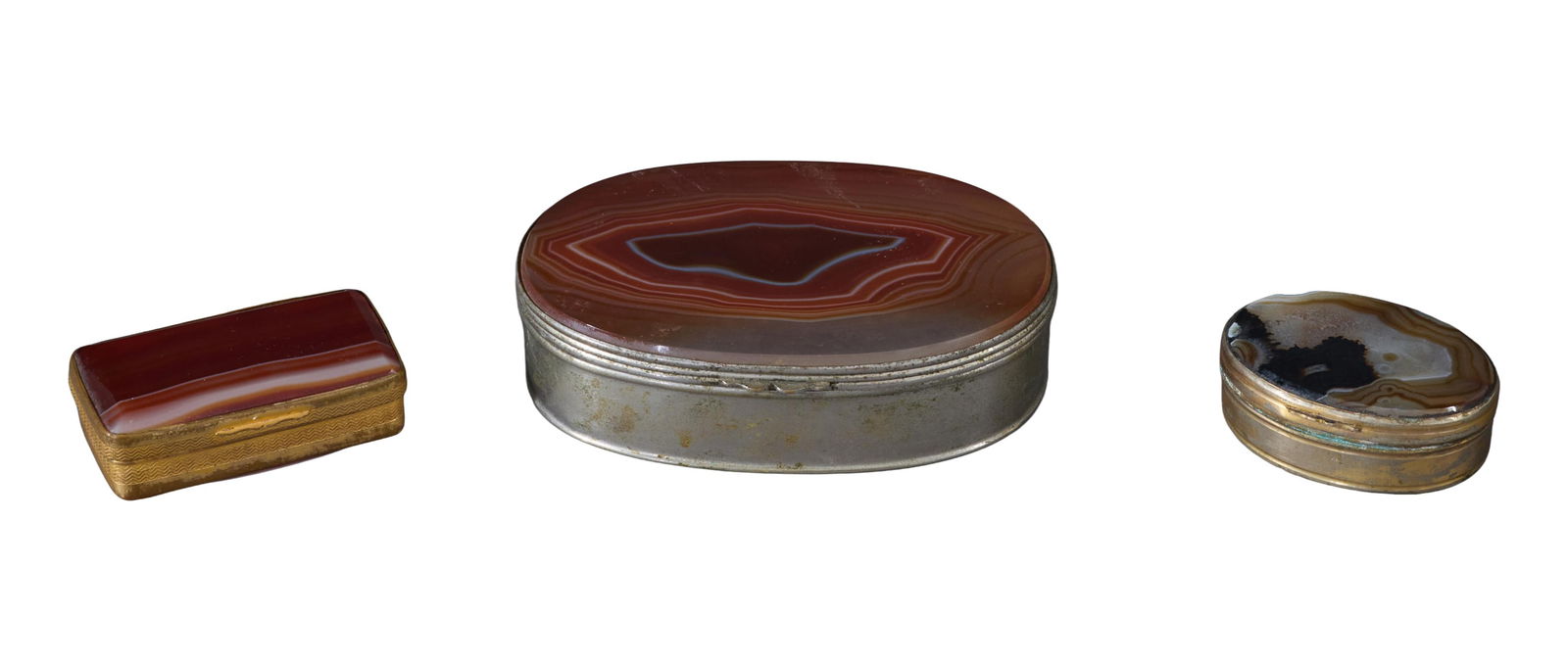Three Agate and Metal Pill Boxes, 19th c., Largest- H.- 1 in., W.- 3 7/8 in., D.- 2 5/8 in. (3 Pcs.): Three Agate and Metal Pill Boxes, 19th c., two of oval form and one rectangular with silver overlay, Largest- H.- 1 in., W.- 3 7/8 in., D.- 2 5/8 in. (3 Pcs.)