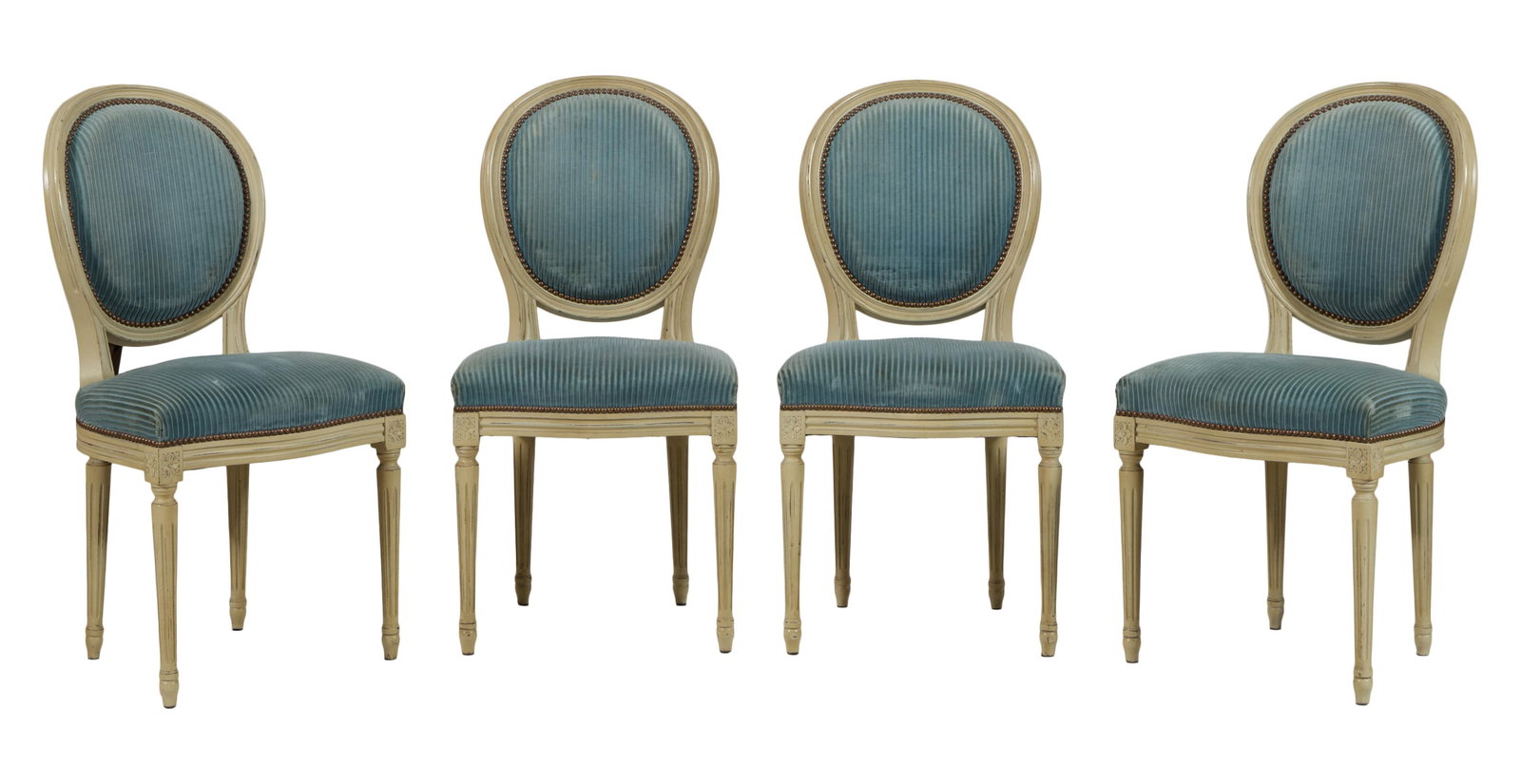 French Louis XVI Style Gris Peinte Dining Chairs, early 20th c., Each- H.- 38 in., W.- 19 in., D.-: French Louis XVI Style Gris Peinte Dining Chairs, early 20th c., the upholstered oval moulded backs over serpentine seat rails joining rosette blocks, spool turned fluted tapered legs with toupie feet