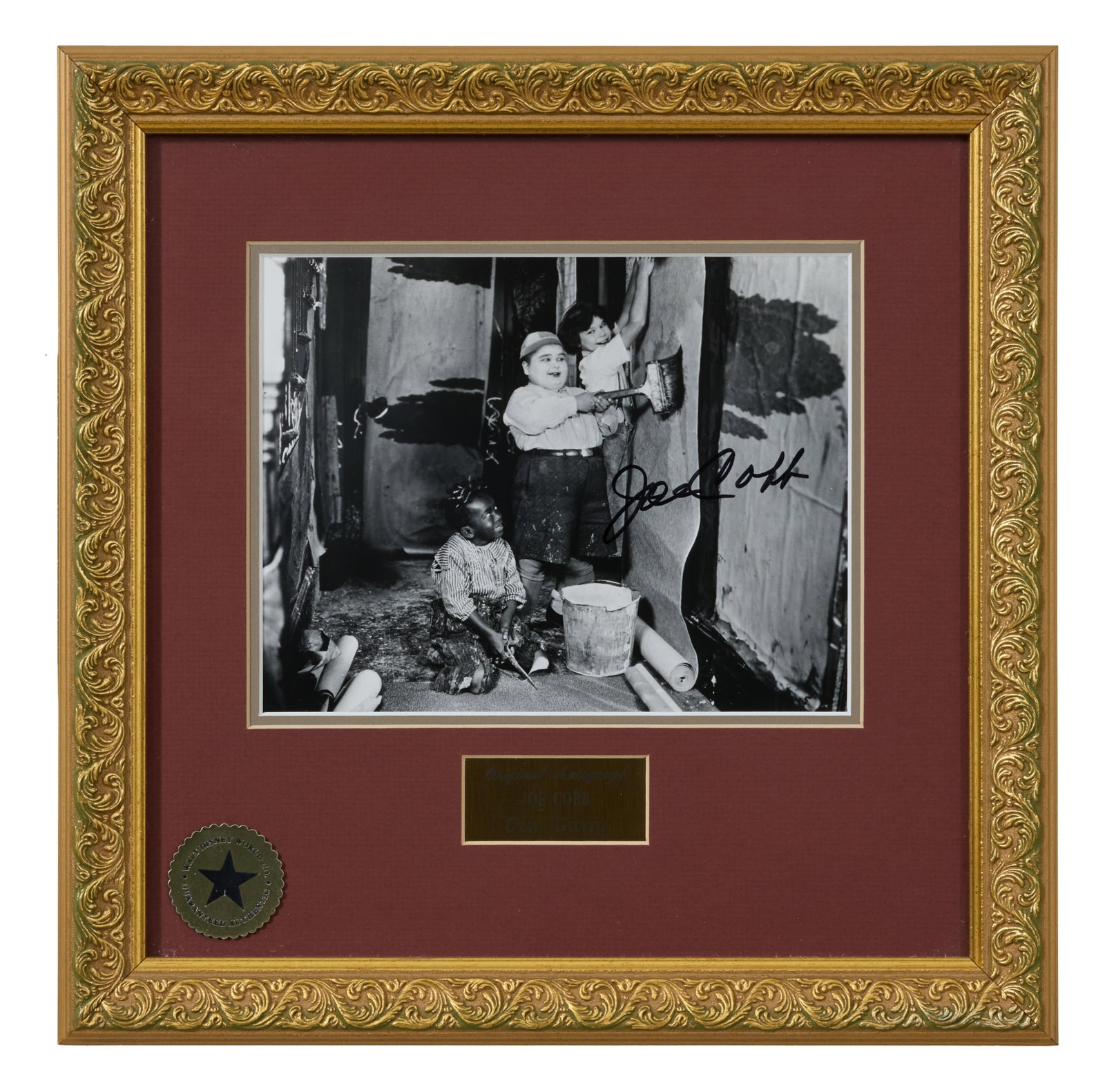Joe Cobb, aka Fat Boy, Autographed Memorabilia from "Our Gang (Little Rascals)," Overall- H.- 15 1/4: Joe Cobb, aka Fat Boy, Autographed Memorabilia from "Our Gang (Little Rascals)," with sharpie signed film still, presented with a gilt plaque and Walt Disney guarantee of authenticity, in a giltwood f