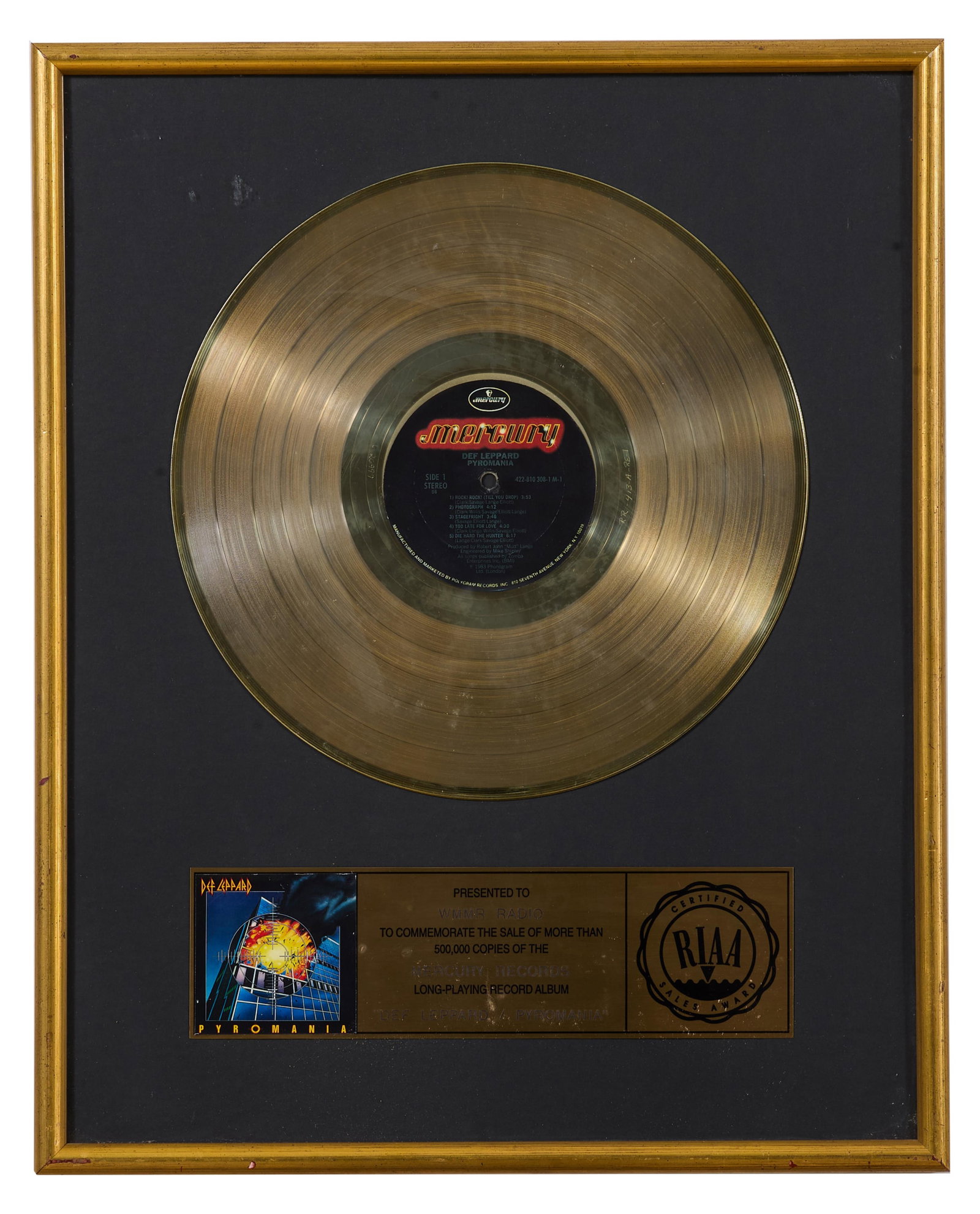 Def Leppard "Pyromania" Memorabilia, Overall- H.- 20 3/4 in., W.- 16 3/4 in.: Def Leppard "Pyromania" Memorabilia, with 24 karat gold LP, limited edition commemorating one half million sales of the album, inset with dedication plaque, presented in a wood frame, Overall- H.- 20 