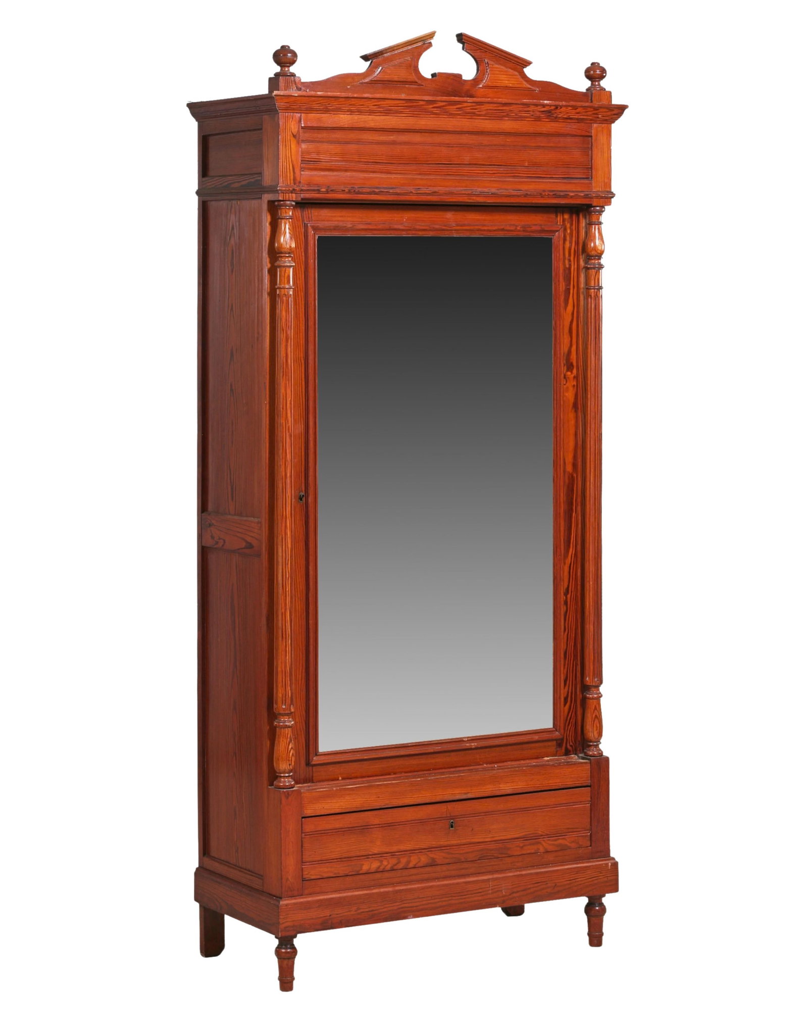 French Provincial Napoleon III Pine Bonnetiere, late 19th c., H.- 85 1/2 in., W.- 37 1/2 in., D.- 17: French Provincial Napoleon III Pine Bonnetiere, late 19th c., the finialed broken pediment over mirrored door flanked by columnettes, lower base drawer, toupie feet, H.- 85 1/2 in., W.- 37 1/2 in., D.