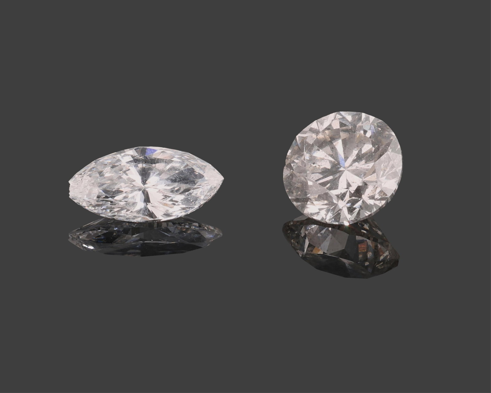 Two Loose Diamonds, Total Diamond Wt- 1.12 carats (2 Pcs.): Two Loose Diamonds, one 0.74 round carat brilliant cut; the other 0.38 carat marquise cut, Total Diamond Wt- 1.12 carats (2 Pcs.)