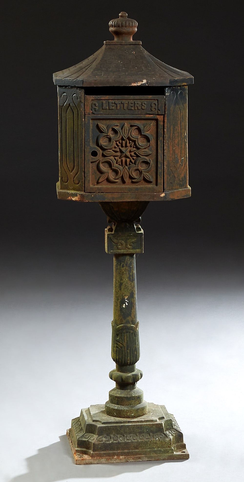 Cast Iron Mailbox, 20th c., H.- 44 in., W.- 13 3/4 in., D.- 12 in.: Cast Iron Mailbox, 20th c., of house form with relief decorated sides, on a stepped turned tapered support, to a square base, H.- 44 in., W.- 13 3/4 in., D.- 12 in.