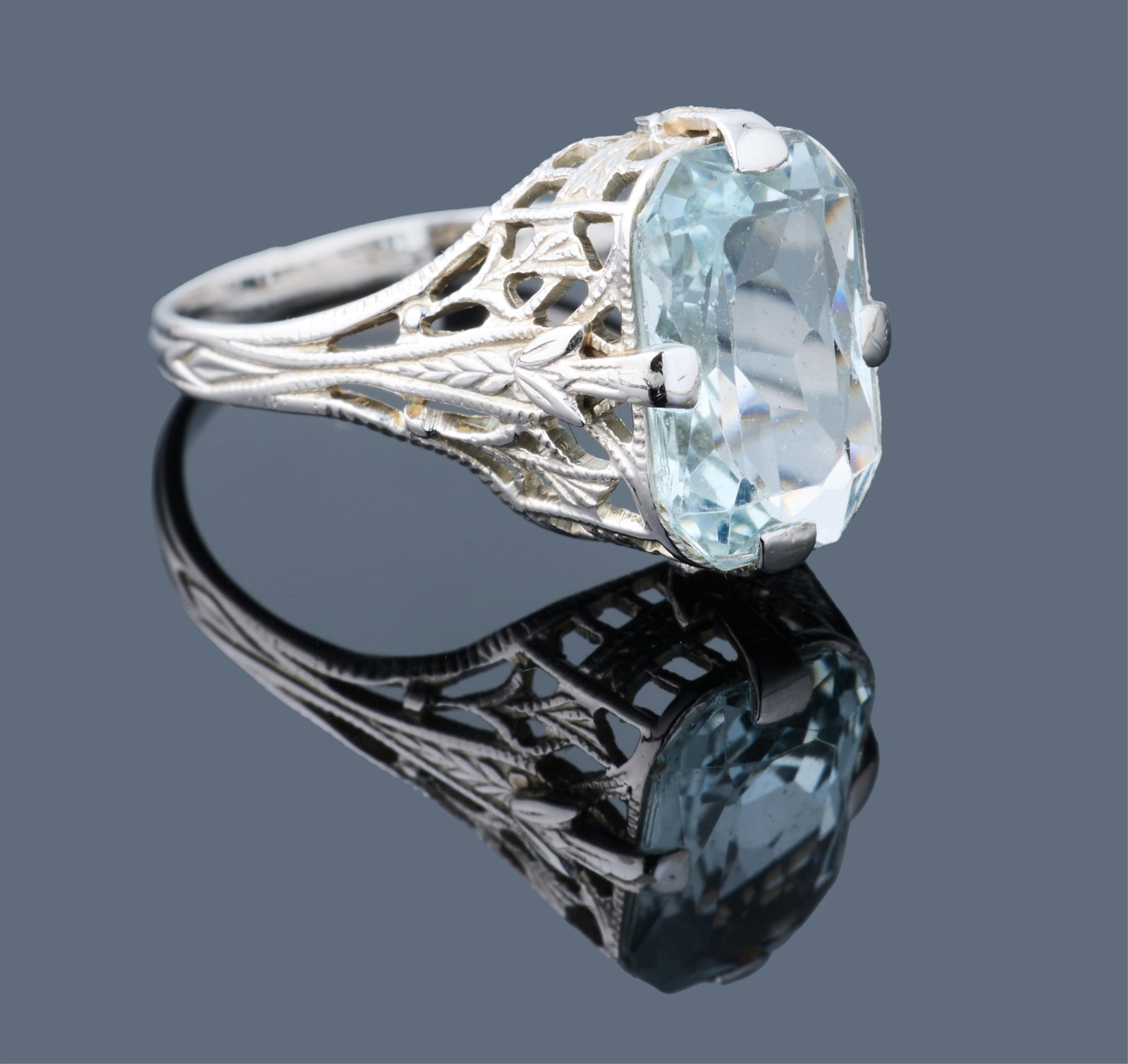 Ladies' 14K White Gold Aquamarine Dinner Ring, App. Wt.- 2.1 grams, Size- 4 1/2.: Ladies' 14K White Gold Aquamarine Dinner Ring, the filigree setting mounted with an approximately 2.89 carat radiant cut aquamarine, App. Wt.- 2.1 grams, Size- 4 1/2. Please Note: All assessments of g
