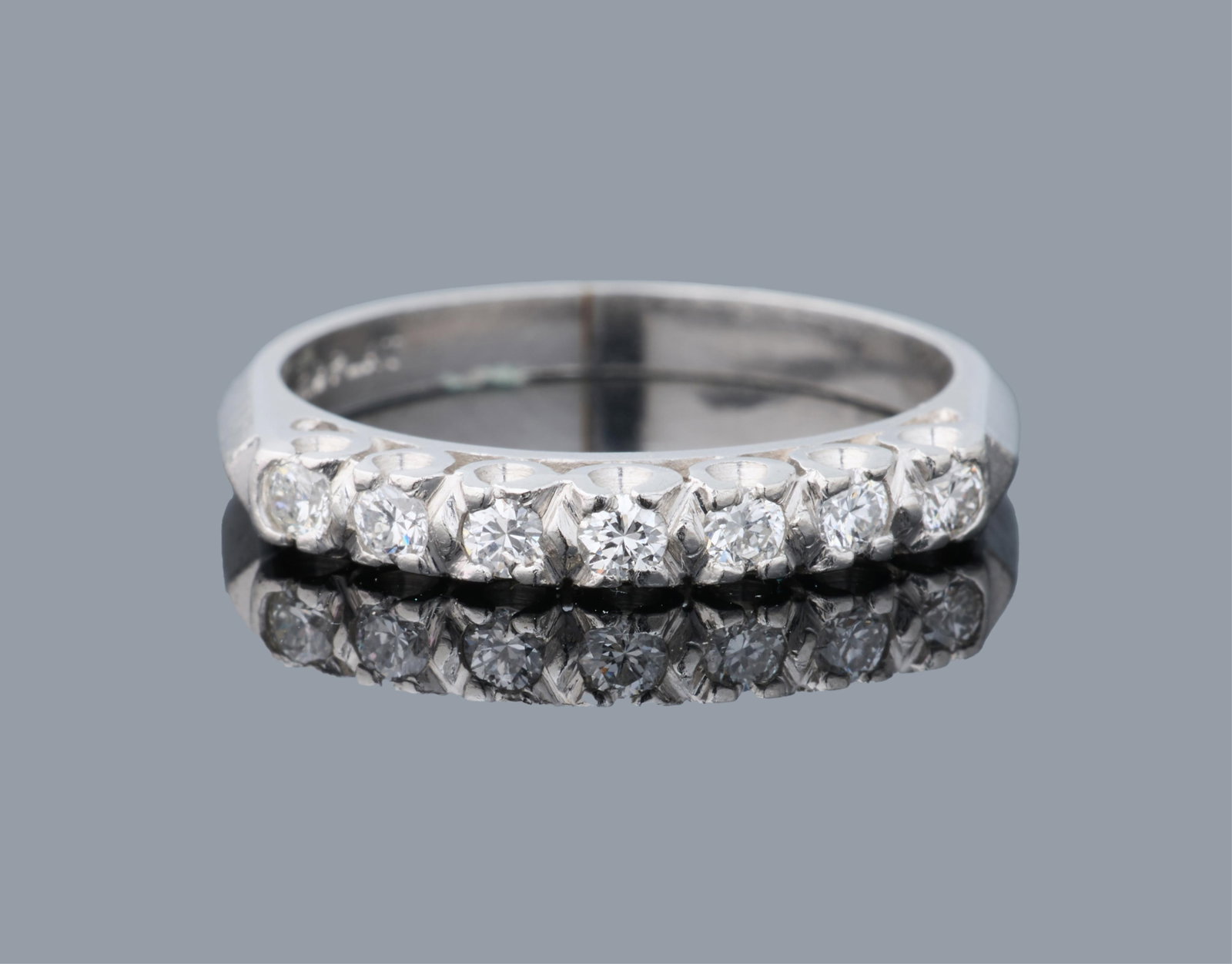 Platinum and Diamond Band, App. Wt.- 3.6 grams, Size- 5 1/4.: Platinum and Diamond Band, fishtail set with approximately 0.20 carat total weight diamonds, App. Wt.- 3.6 grams, Size- 5 1/4. Please Note: All assessments of gemstone weight, color, and/or clarity ar