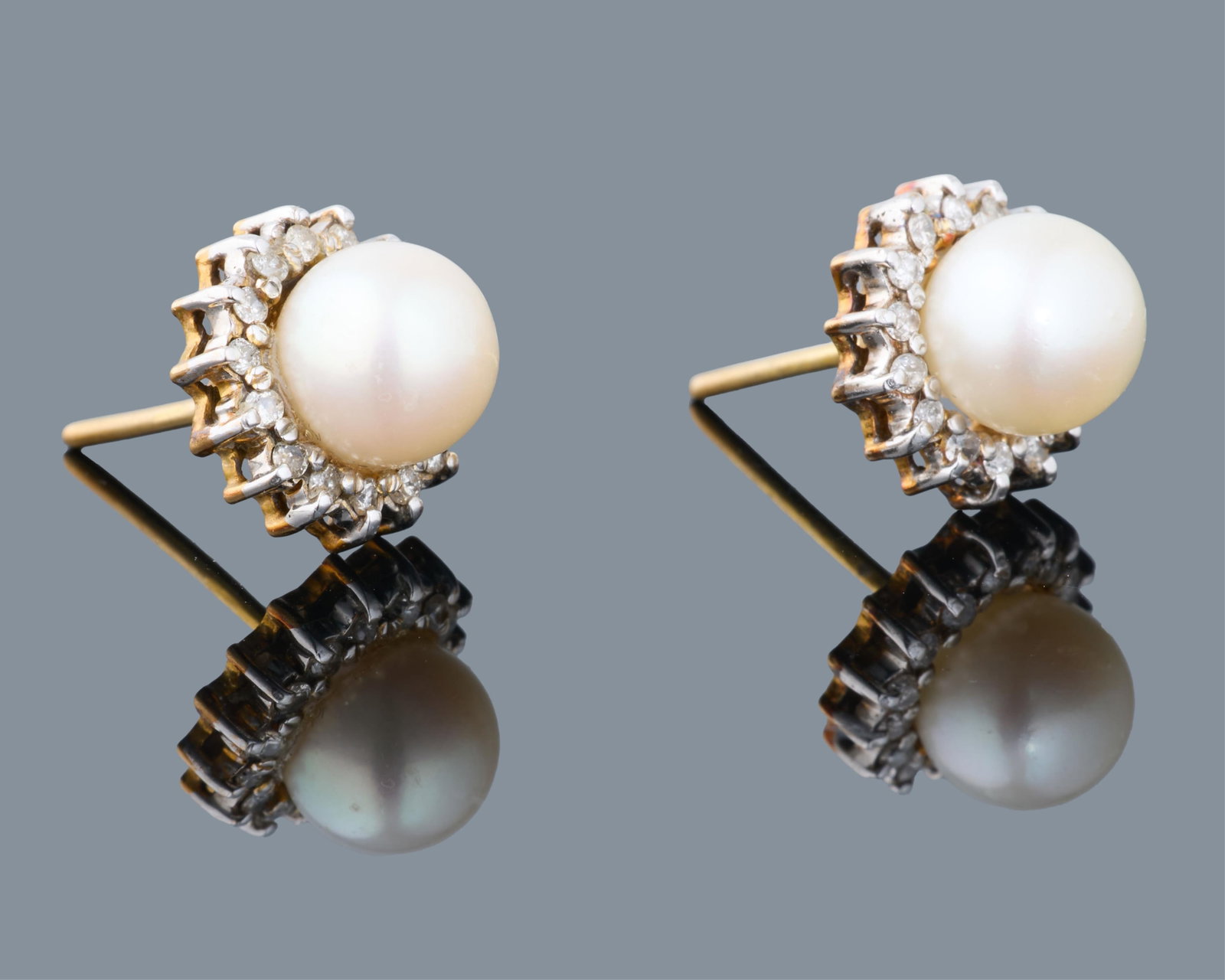 Pair of 14K Varicolor Gold, Pearl and Diamond Earrings, App. Total Diamond Wt.- 0.30 carats; App.: Pair of 14K Varicolor Gold, Pearl and Diamond Earrings, the 8mm white pearls set within halo surrounds mounted with tiny round white diamonds, on friction posts, App. Total Diamond Wt.- 0.30 carats; A