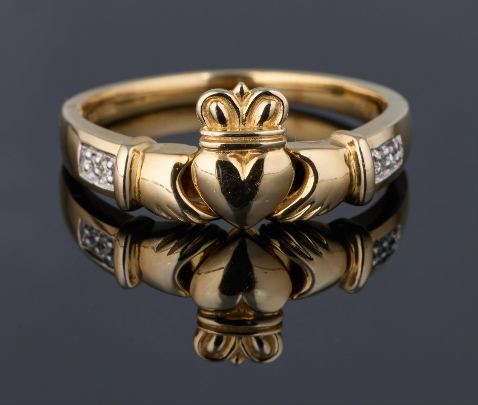 14K Yellow Gold Claddagh Ring, App. Total Wt.- 3.1 grams, Size- 7.: 14K Yellow Gold Claddagh Ring, the central motif flanked by two round diamonds on each side totaling approximately 0.04 carats, App. Total Wt.- 3.1 grams, Size- 7. Please Note: All assessments of gems