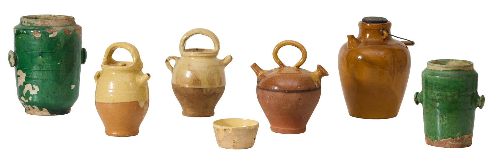 Group of Seven Pieces of French Provincial Glazed Pottery, 19th c., Largest Pitcher- H.- 9 3/4 in.,: Group of Seven Pieces of French Provincial Glazed Pottery, 19th c., consisting of four walnut oil pitchers, two handles vessels and a sieve, Largest Pitcher- H.- 9 3/4 in., W.- 7 1/2 in., D.- 6 1/2 in