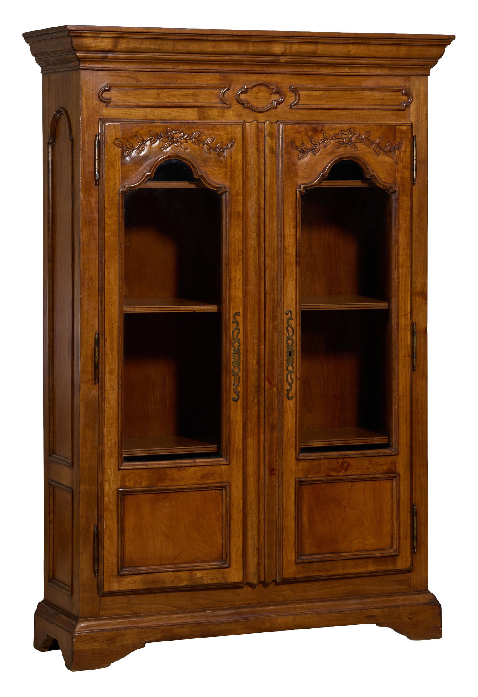 French Louis Philippe Style Cherry Bibliotheque, late 20th c., H.- 83 1/2 in., W.- 57 in., D.- 18: French Louis Philippe Style Cherry Bibliotheque, late 20th c., the stepped cyma cornice over moulded frieze, two bowknot and swag carved glazed doors, shelved interior, moulded base, bracket feet, H.-