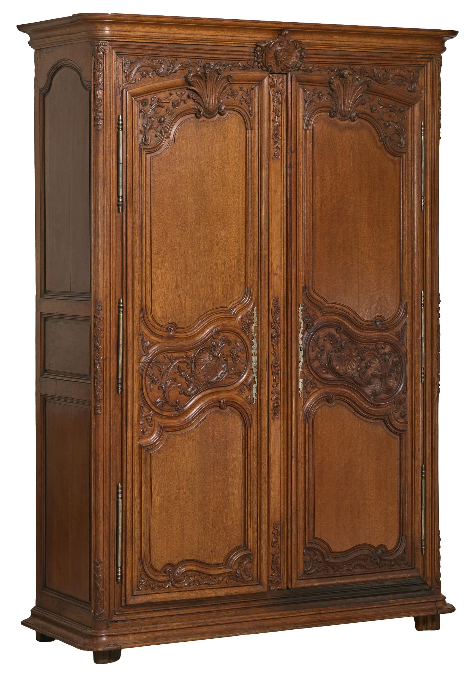 French Louis XIV Style Carved Walnut Armoire, late 19th c., H.- 98 in., W.- 68 in., D.- 26 1/2 in.: French Louis XIV Style Carved Walnut Armoire, late 19th c., the coved cornice with rounded corners, foliate carved central cartouche, relief acanthus carved raised panel doors, rounded stiles into fla